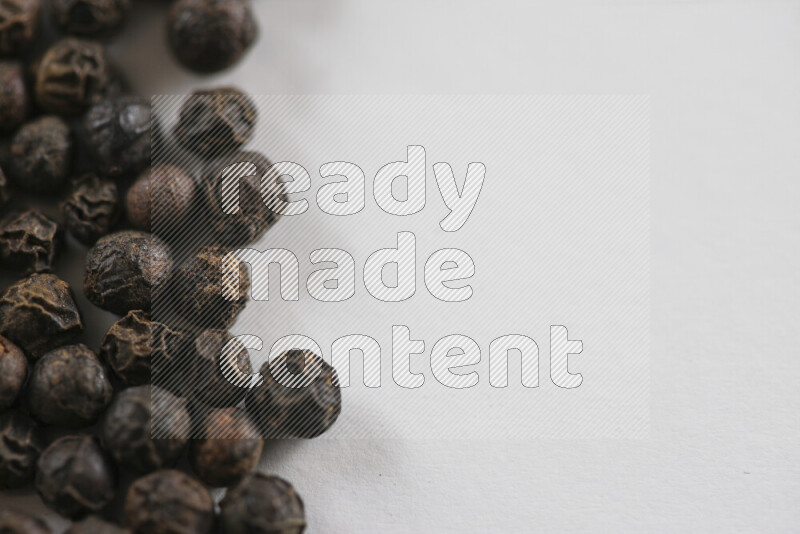 Black pepper beads on white background