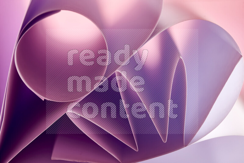 An artistic display of paper folds creating a harmonious blend of geometric shapes, highlighted by soft lighting in purple tones