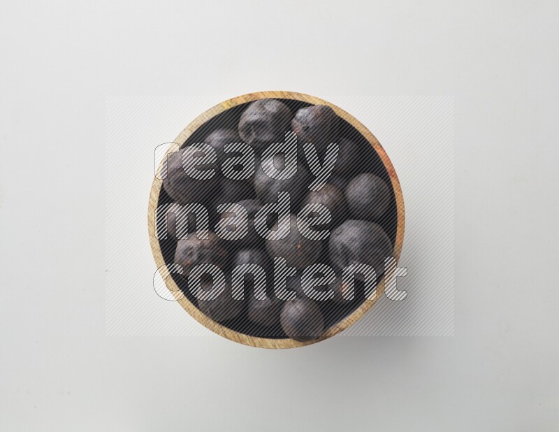 Top-view shot of dried lime (loomi) in a container on white background