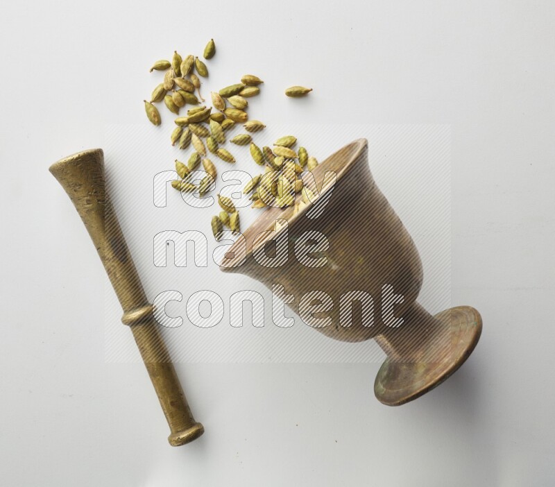 Top-view shot of Cardamon in herbs crusher on white background