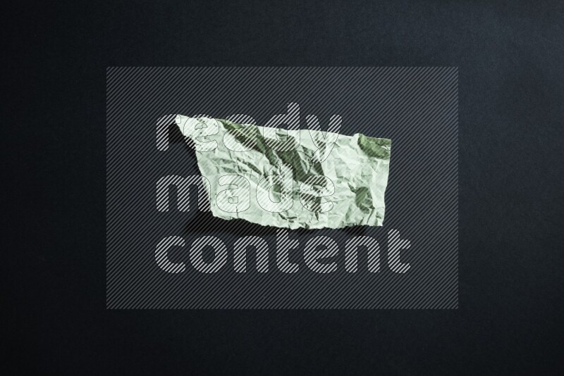 Green paper sheet on black background