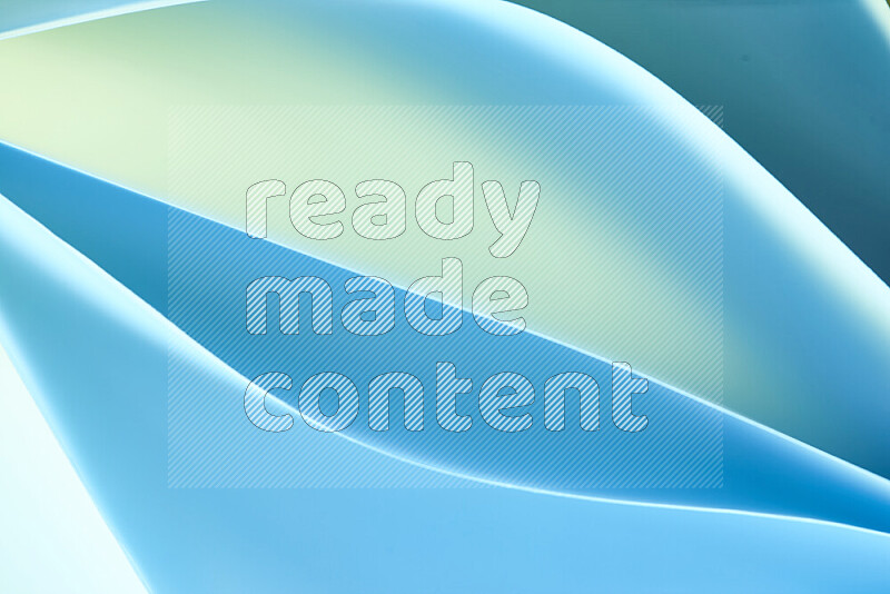 This image showcases an abstract paper art composition with paper curves in green and blue gradients created by colored light