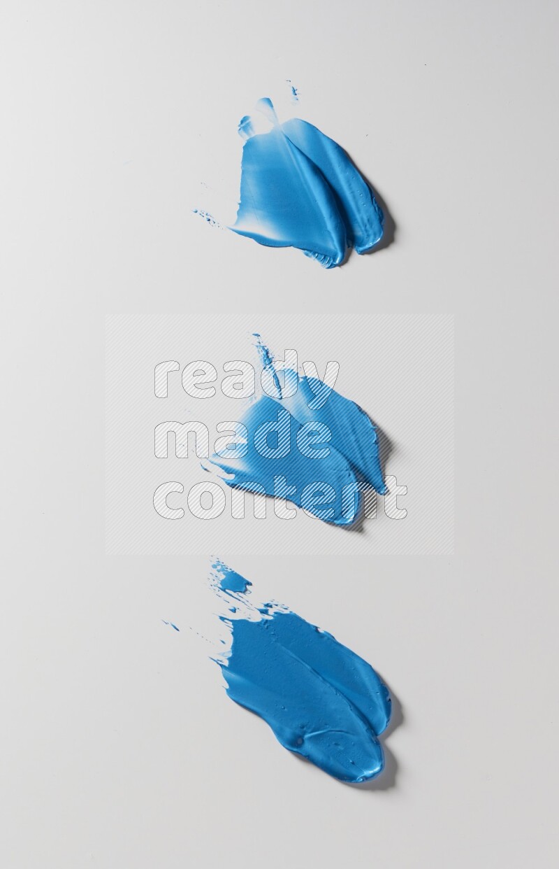 Blue painting knife strokes on white background