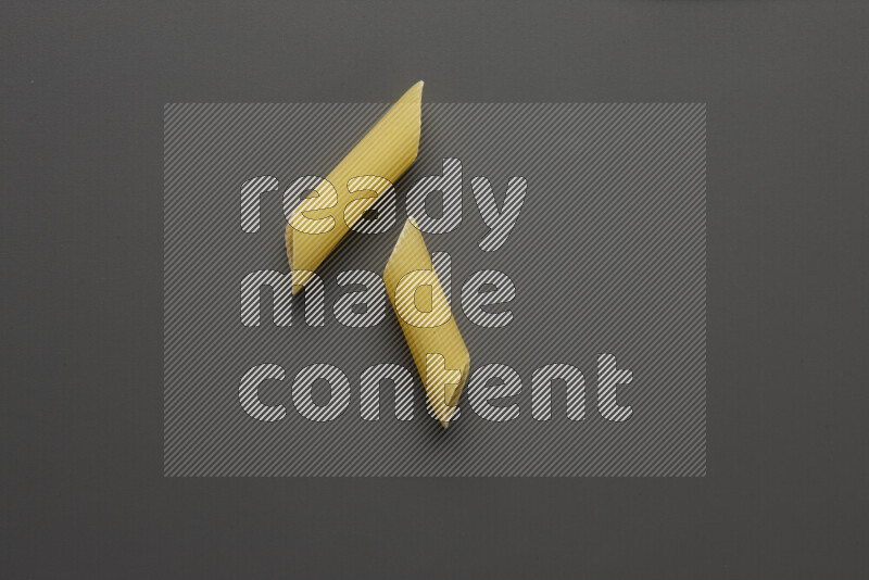 Penne pasta on grey background