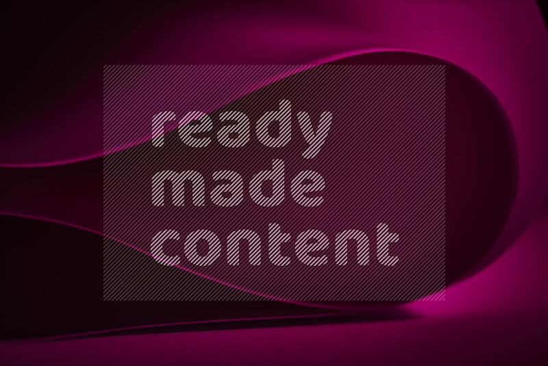 An abstract art piece displaying smooth curves in pink gradients created by colored light