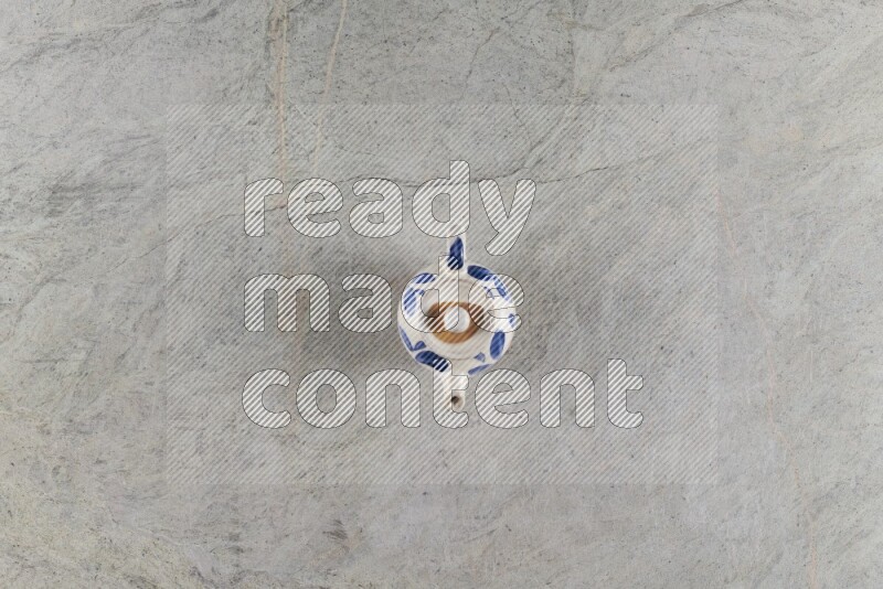 A pottery teapot on grey marble background