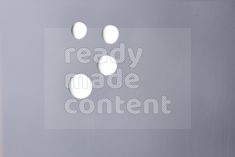 Close-ups of abstract white paint droplets on the surface