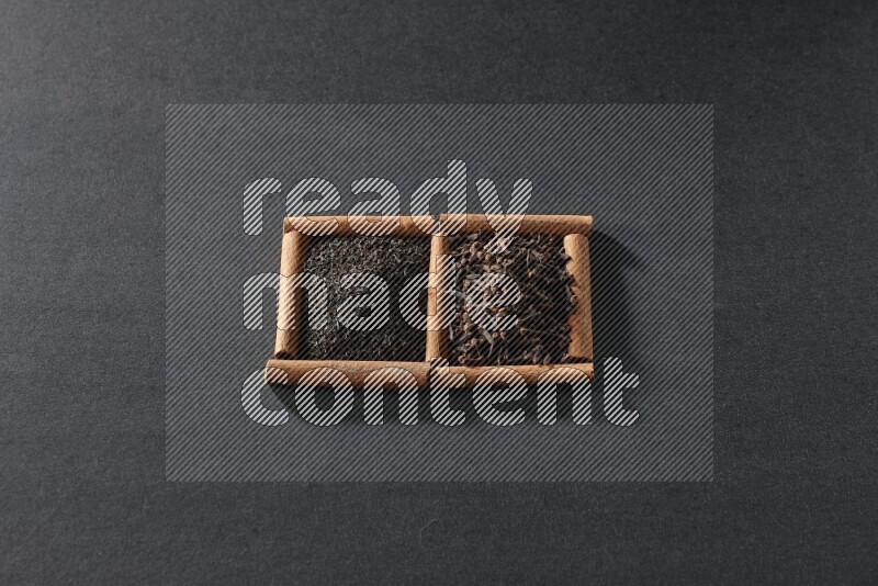 2 squares of cinnamon sticks full of tea and cloves on black flooring