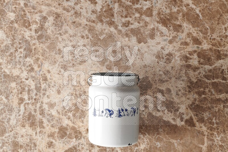 A vintage milk can on beige marble background