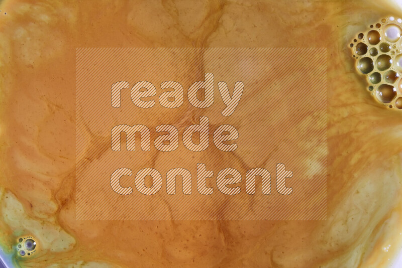 A close-up of abstract different swirling patterns in orange