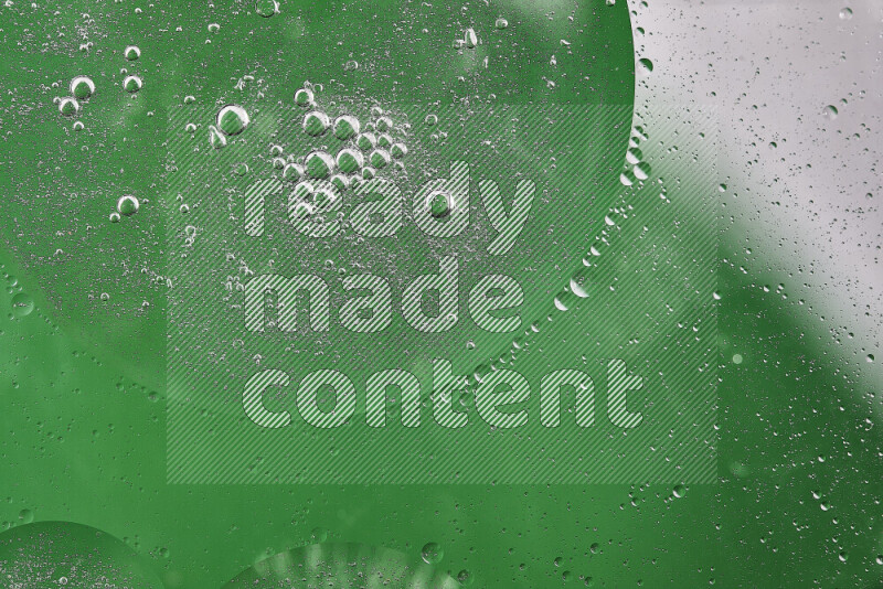 Close-ups of abstract oil bubbles on water surface in shades of white and green