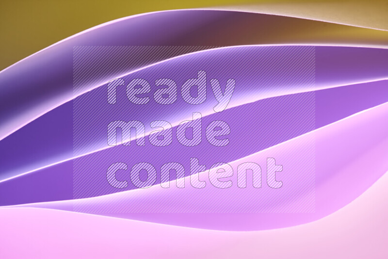 This image showcases an abstract paper art composition with paper curves in purple and gold gradients created by colored light