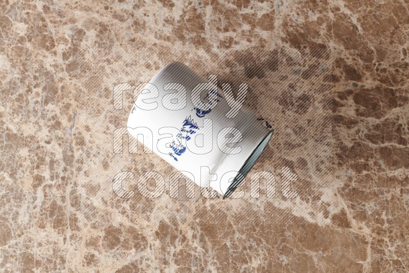 A vintage milk can on beige marble background