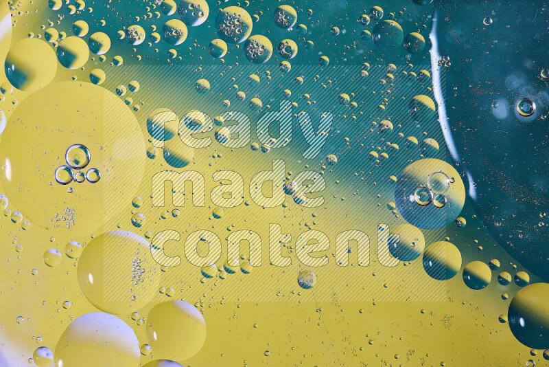 Close-ups of abstract oil bubbles on water surface in shades of blue and yellow