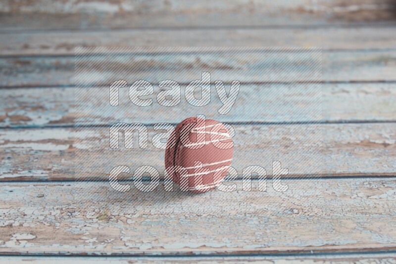 45º Shot of Red Poppy Flower macaron on light blue wooden background
