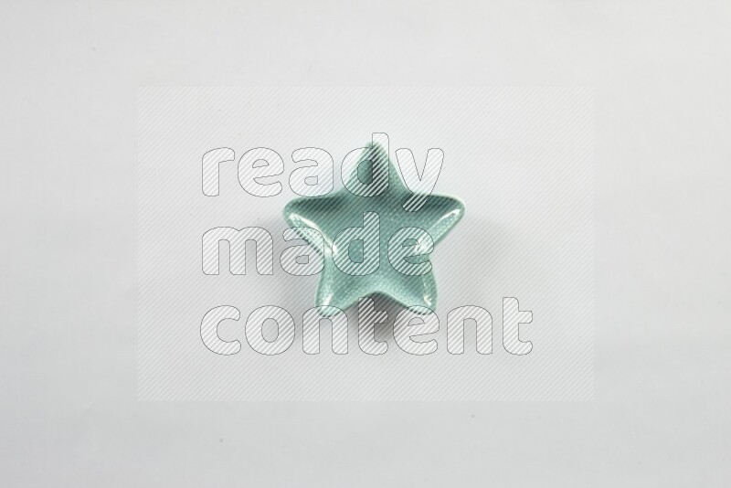 A colored pottery star plate on white background