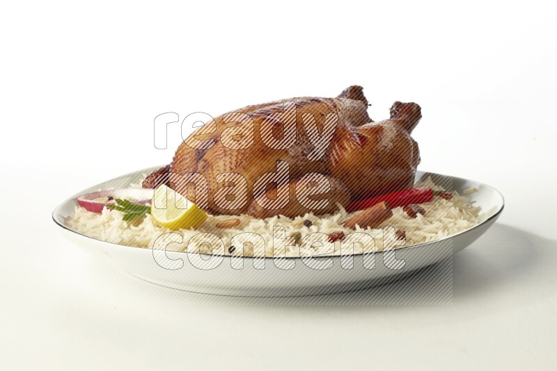 white  basmati Rice with  whole roasted chicken  on a white plate with a silver rim direct  on white background