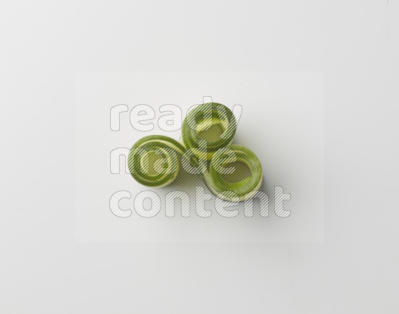 Three cucumber ribbons on a white background