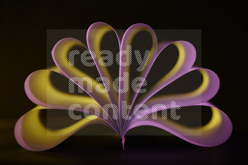 An abstract art piece displaying smooth curves in yellow and pink gradients created by colored light