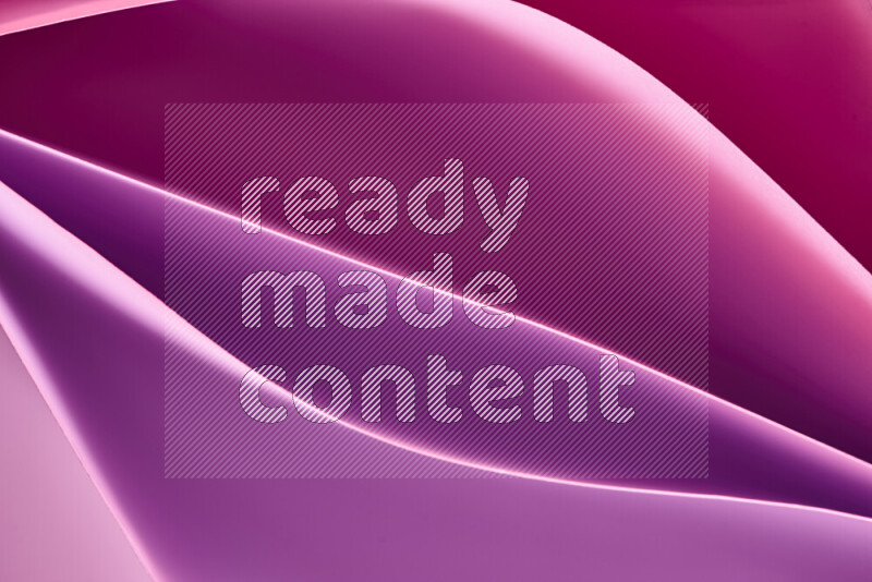 This image showcases an abstract paper art composition with paper curves in purple and pink gradients created by colored light