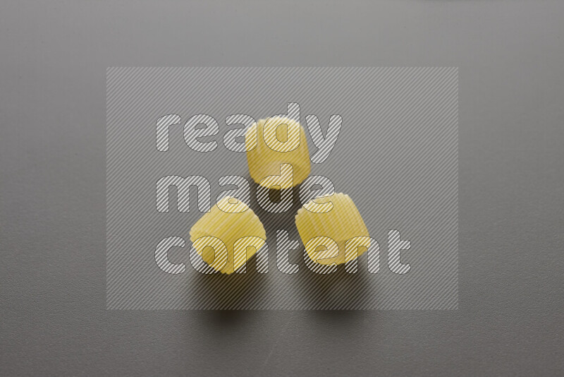 Big rings pasta on grey background