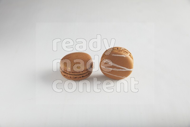 45º Shot of of two assorted Brown Irish Cream, and Brown Coffee macarons  on white background
