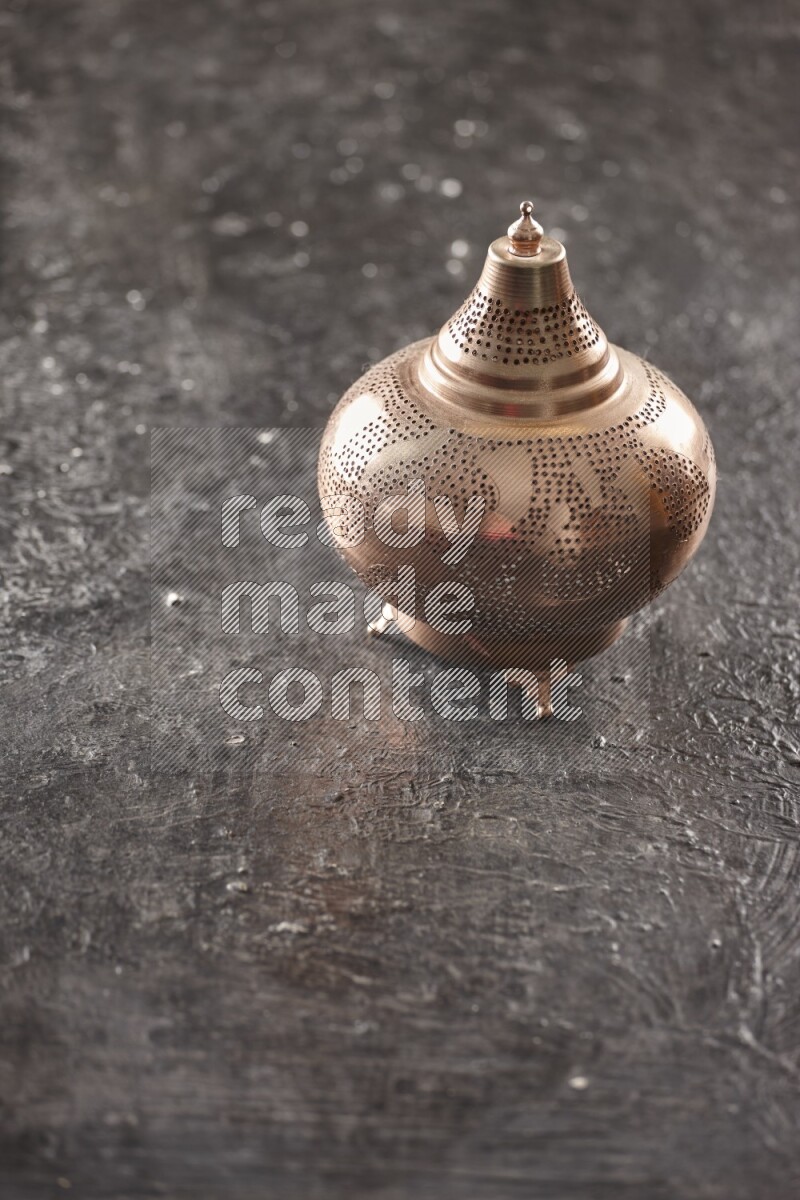 A lantern placed on a textured black background