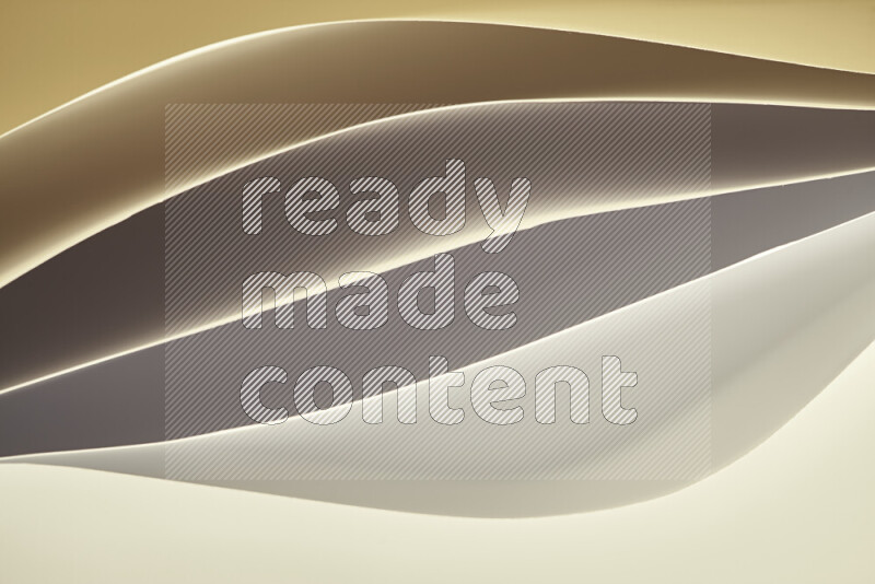 This image showcases an abstract paper art composition with paper curves in gold gradients created by colored light