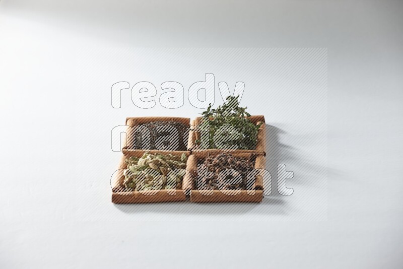 4 squares of cinnamon sticks full of tea, cardamom, mint and cloves on white flooring