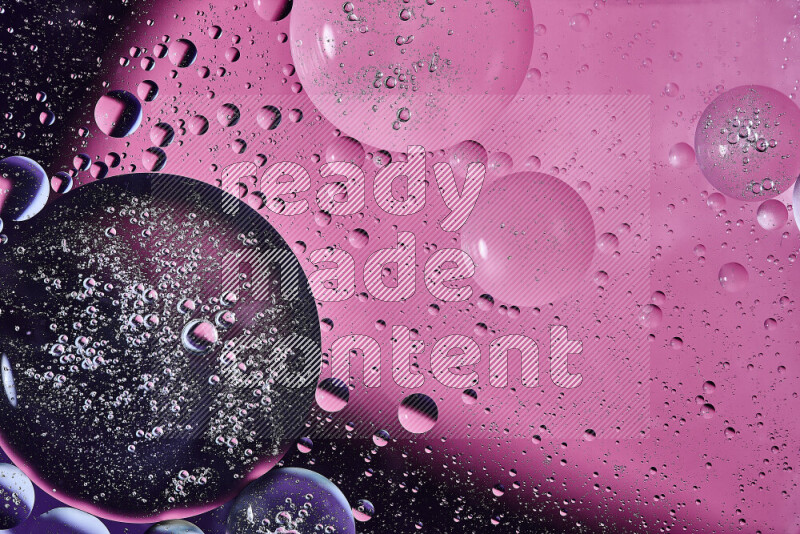 Close-ups of abstract oil bubbles on water surface in shades of purple and pink