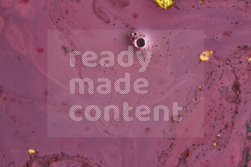 A close-up of abstract swirling patterns in red with colored particles