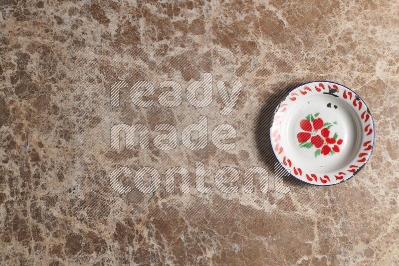 A vintage metal plate on beige marble background