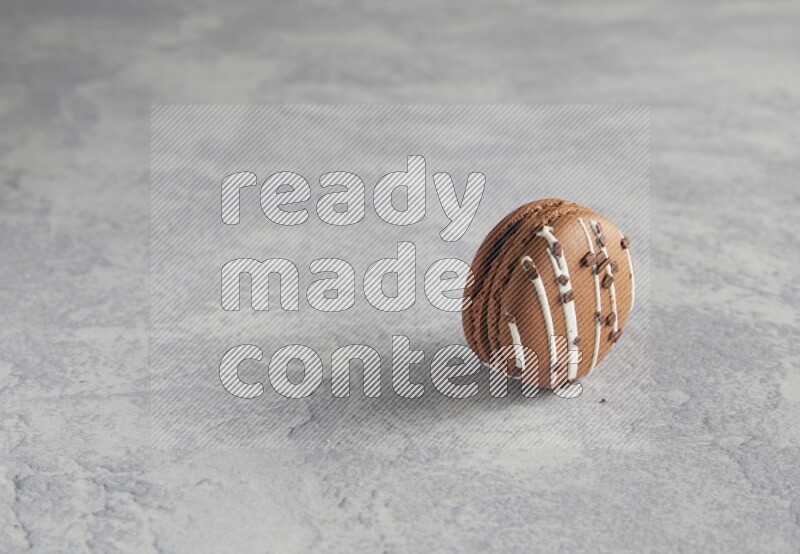 45º Shot of Brown white Chocolate Caramel macaron on white  marble background