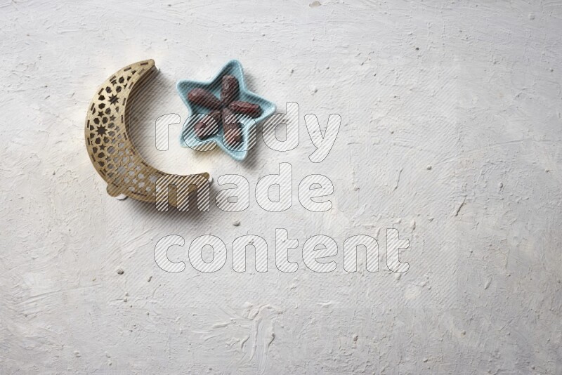 Dates in a pottery bowl with a lantern in a light setup