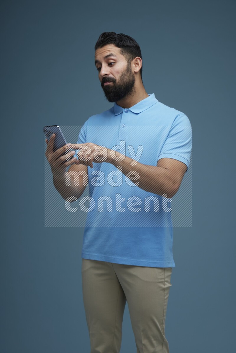 A man Swiping in a blue background wearing a Blue shirt
