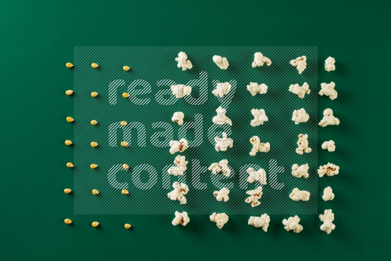 Popcorn flakes and seeds on a green background in a top view shot