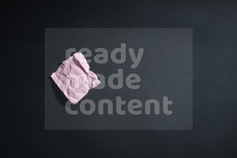 Crumpled multicolored paper on black background