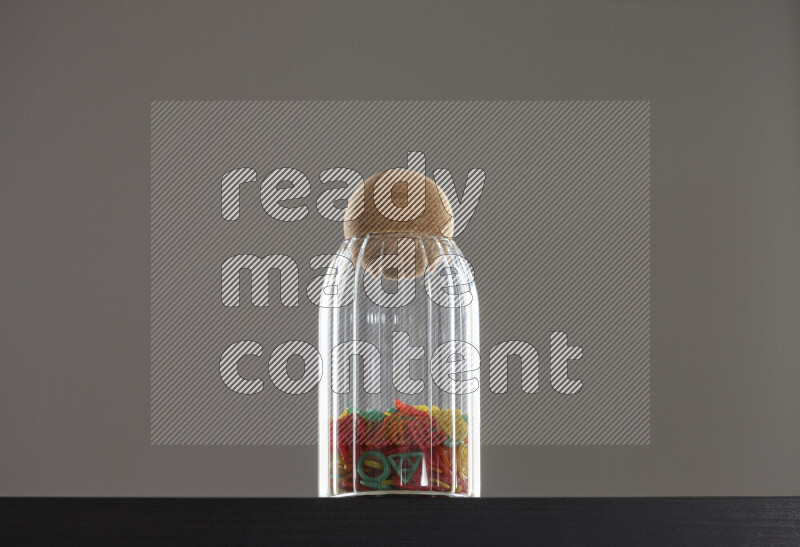 Snacks in a glass jar on black background