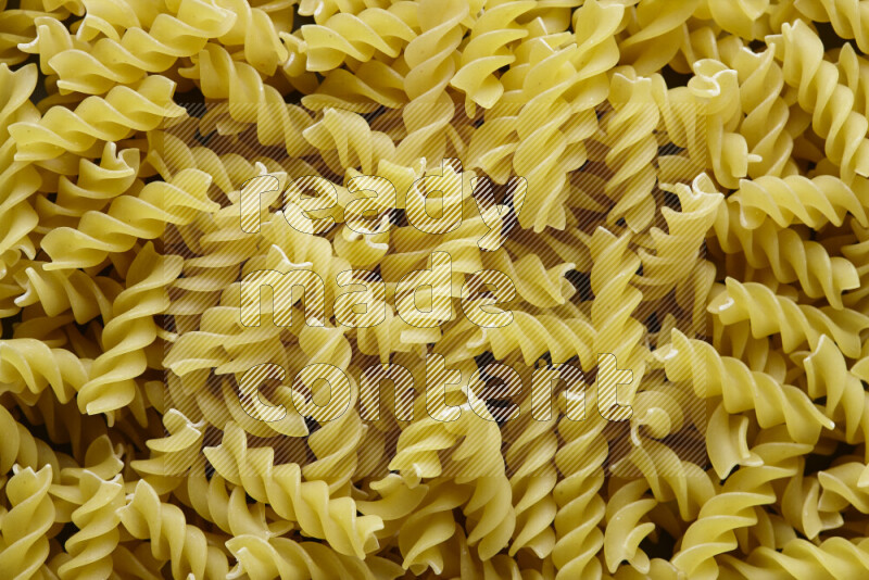 Fusilli pasta on grey background