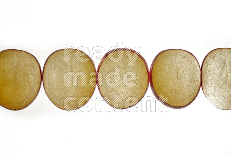 Plum slices on illuminated white background
