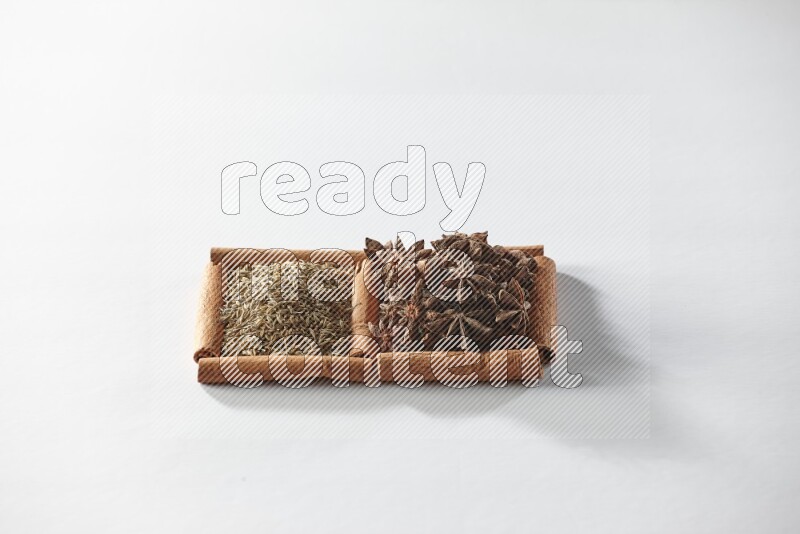 2 squares of cinnamon sticks full of star anise and cumin on white flooring