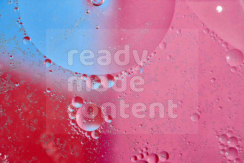 Close-ups of abstract oil bubbles on water surface in shades of blue, red and pink