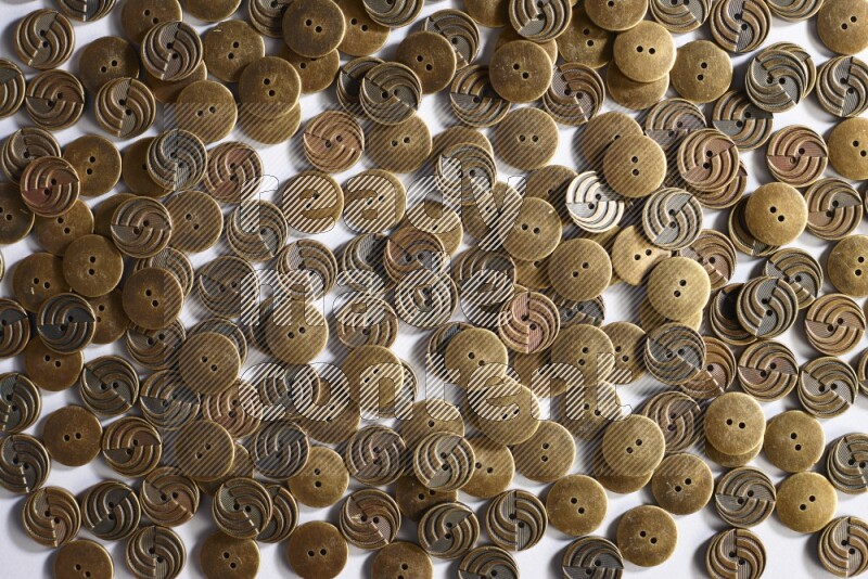 Metal buttons placed on grey background