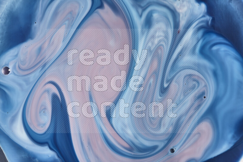 A close-up of abstract swirling patterns in blue, red and white
