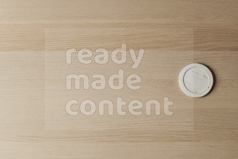 A pottery coaster on light wooden background