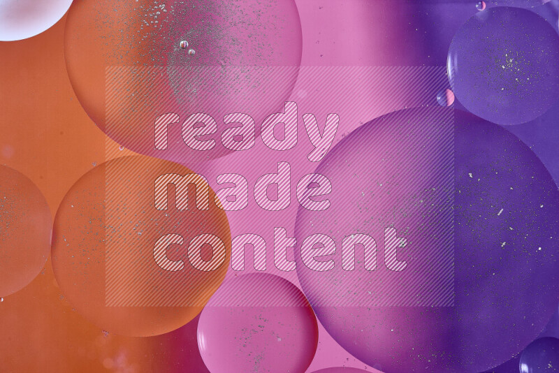 Close-ups of abstract oil bubbles on water surface in shades of purple, orange and pink
