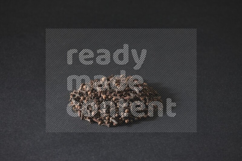 Cloves in a circle shape on a black flooring