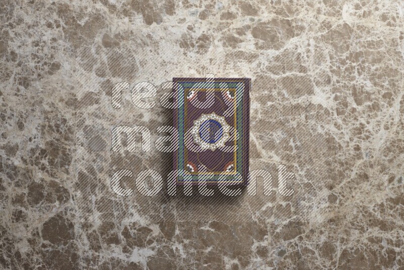 The holy Quran on beige marble background