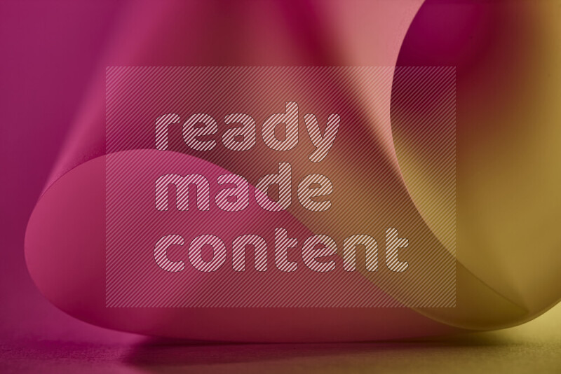 An abstract art piece displaying smooth curves in gold and pink gradients created by colored light