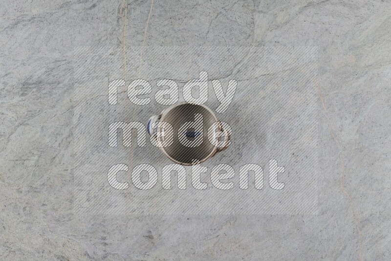 A multicolored pottery Bowl on grey marble background
